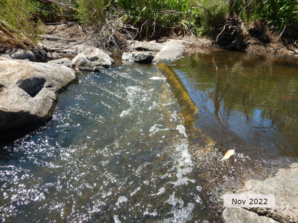 An image showing water flowing over the flow control structure (weir) for the department's gauging station 616001 (Karl's Ranch), on Wooroloo Brook.