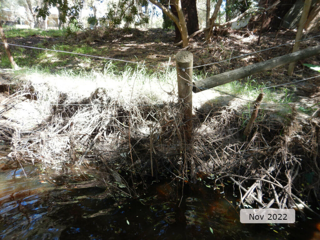 An image showing fencing collapsing because of river bank erosion. 